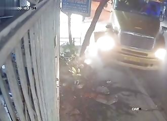 A passer-by narrowly misses being run over by a truck