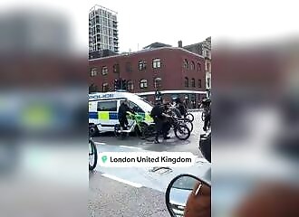 A bike gang stops police from advancing towards an emergency