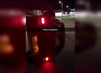 Youngsters have fun knocking over a car in the Netherlands