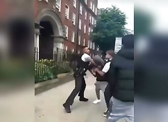 A policeman hits a man who intervenes during an arrest