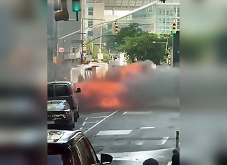 Manhattan: A vehicle bursts into flames and explodes in the heart of the financial district as passersby look on