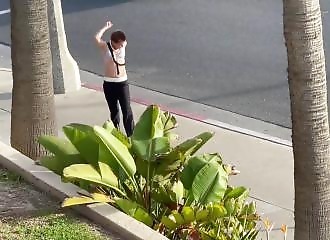 Vêtu d'un haut de maillot pour fille, ce drogué fait le show dans la rue