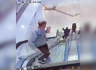  He pushes a stranger off an escalator (Warning - shocking) 