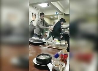 Il tente de manger son diner alors qu'une bagarre générale fait rage à côté de lui