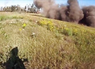 A Ukrainian soldier walks under Russian artillery fire