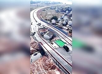 Detached house in the middle of a highway in China