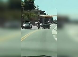  A motorcyclist attacks a motorist's car, karma strikes him down 