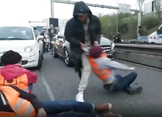 Environmental activists are pushed off the highway by angry people