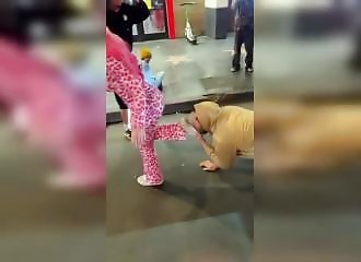 A man plays with a dog and is spat on by his girlfriend