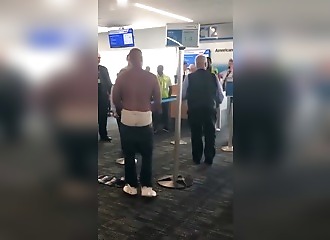 Meltdown at the airport: Shirtless, he yells at American Airlines staff