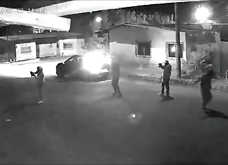 He pulls the pin out of a grenade before getting into the car