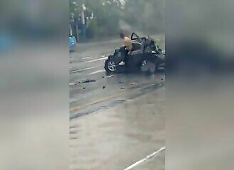 Driver escapes unhurt from car crushed between two trucks