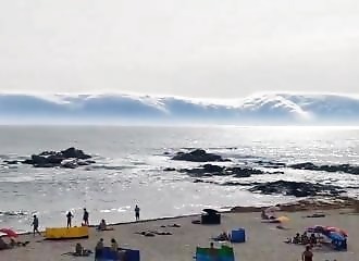 a strange cloud formation skirts the beach in Portugal
