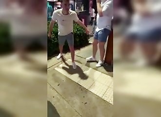 An overconfident young man tries to uproot a pole after a few beers