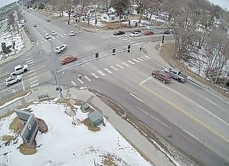 Two cars fall into a gaping hole in the middle of an intersection