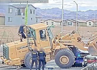 A man attempts to run over an officer with an excavator and is shot.