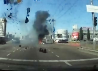 A Russian missile falls between two lucky motorists