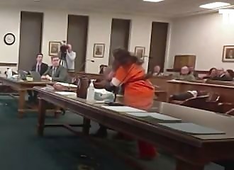 A woman who decapitated her husband and cut off his penis attacks her lawyer in court