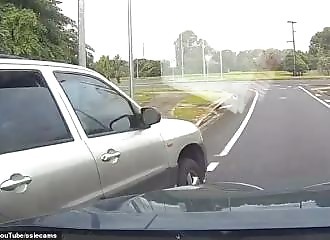 A knife-wielding driver is dragged from her car and thrown to the ground