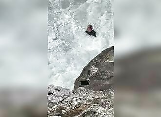  A lifeguard rescues a surfer beset by huge waves 