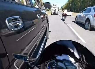 Thinking himself above the law, this cop pushes a motorcyclist on the road