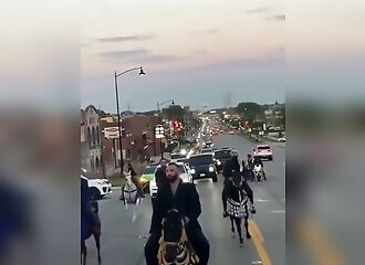 Riders block traffic in the middle of a road in Illinois