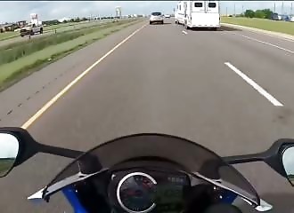 A motorcyclist drives too fast and is caught by a car driver who cuts him off