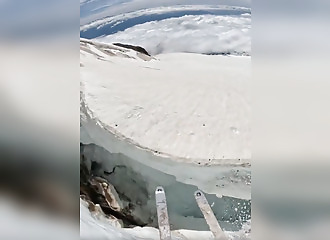 skier narrowly avoids an accident above the clouds