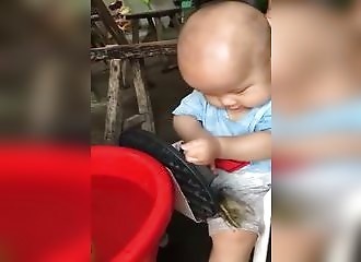 Un enfant s’amuse à gober une grenouille encore vivante