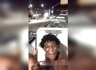 2 young people show off by traveling on the roof of a bus