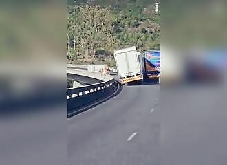 Extreme winds blow truck and caravan off bridge