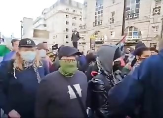 Hooded pro-Palestinians try to steal an English flag from patriots, and get punched in return