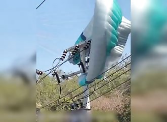 Hanging from a high-voltage pylon, he miraculously escaped unharmed.