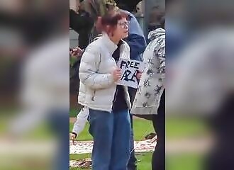 A woman reacts when a man pulls out an Israeli flag at a pro-Palestinian rally